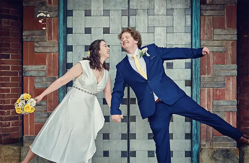 Newlyweds laughing outside registry office in Worcester